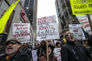 Demonstrators hold signs and march toward Federal Plaza protesting President Donald Trump's executive order blocking visitors from seven predominantly Muslim nations in New York on Jan. 29, 2017. (MUST CREDIT: Jeenah Moon/Bloomberg)
