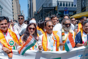 From left, Senior Advisor to FIA Dr. Sudhir Parikh, unidentified guest, President of FIA Kenny Desai, Sri Sri Ravishankar, India’s Consul General in New York Randhir Jaiswal, leading the FIA India Day Parade August 20, 2023. PHOTO:  Deval Parikh